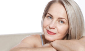 A woman smiling and showing the results of a deep plane facelift in Cincinnati